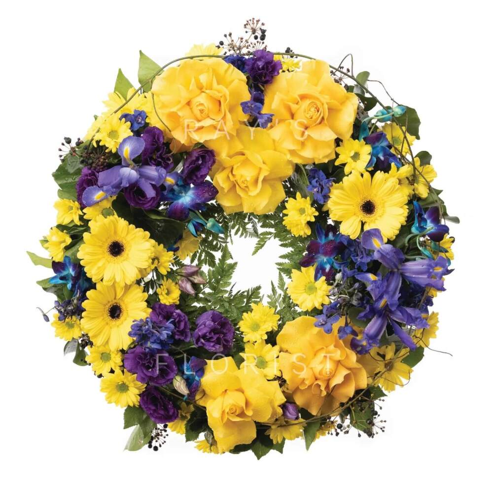Yellow, Blue & Purple Funeral Wreath with Seasonal Flowers